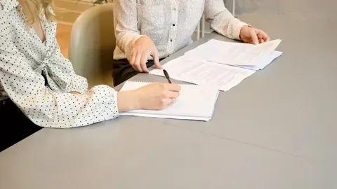 Two estimates reviewed side by side during an insurance appraisal